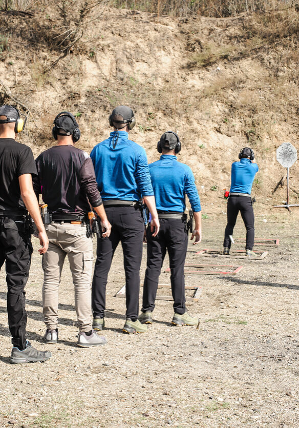 Young people on tactical gun training classes. Shooting and Weapons. Outdoor Shooting Range