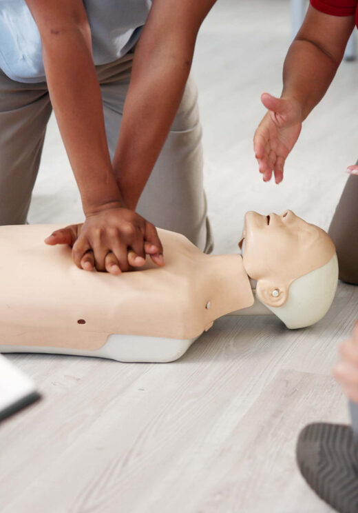 People, mannequin or hands in office for CPR, first aid workshop or chest compression lesson. Colleagues, emergency practice or dummy in agency for life saving procedure, notes or employee engagement